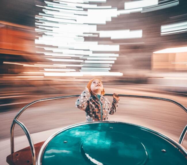 child-having-fun-on-merry-go-round